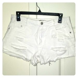 Distressed white jean shorts